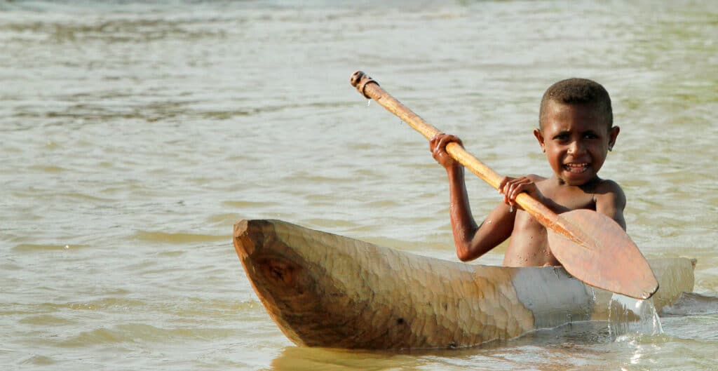 A boy in Morobe Harbour, a key location visited during expeditions to Papua New Guinea aboard the Paspaley Pearl boutique vessel